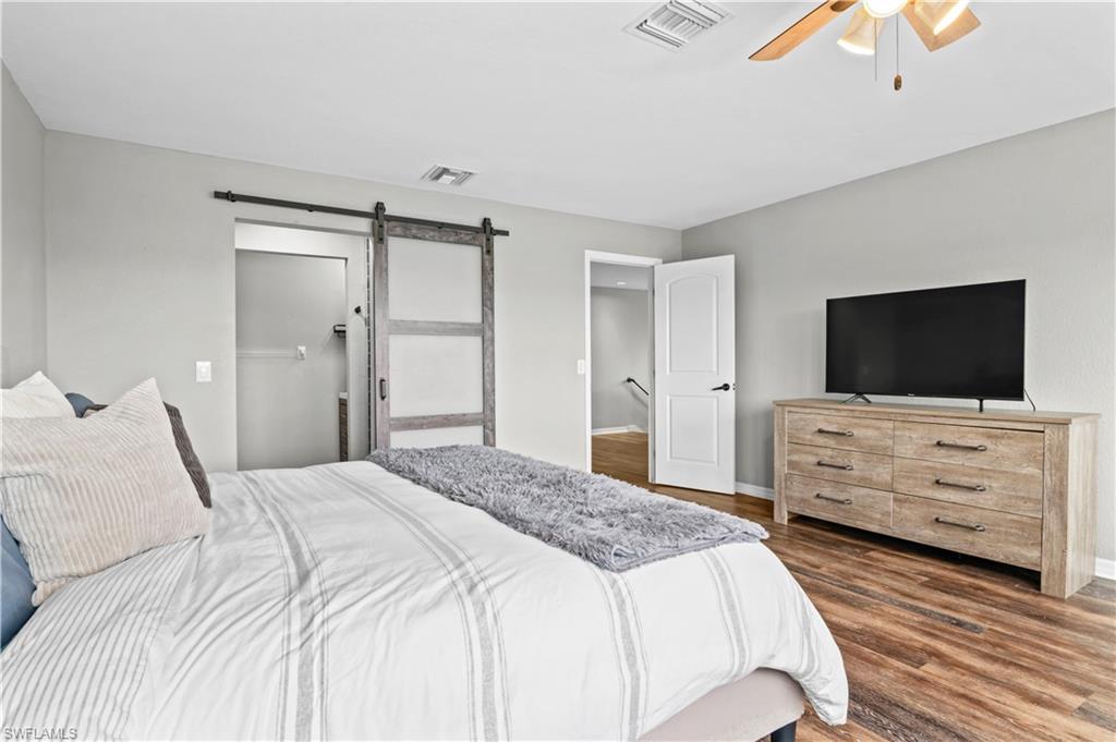 2123 Old Burnt Store Road North Cape Coral, FL 33993 - Photo 29 of 40 a bedroom with a bed and flat screen tv