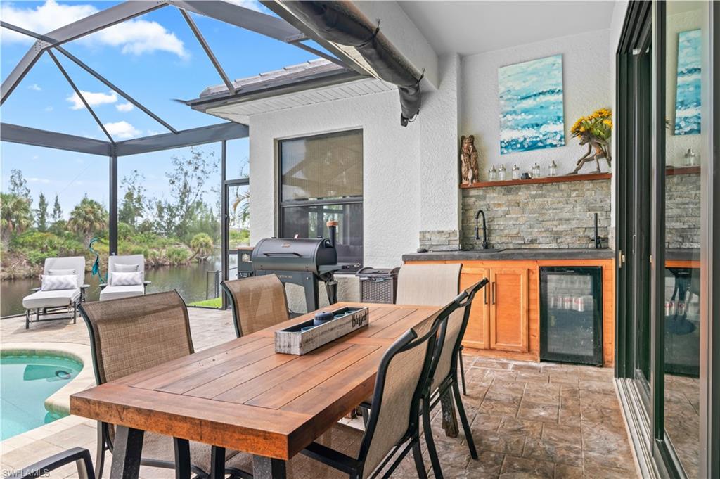 2123 Old Burnt Store Road North Cape Coral, FL 33993 - Photo 37 of 40 a dining room with furniture and a floor to ceiling window
