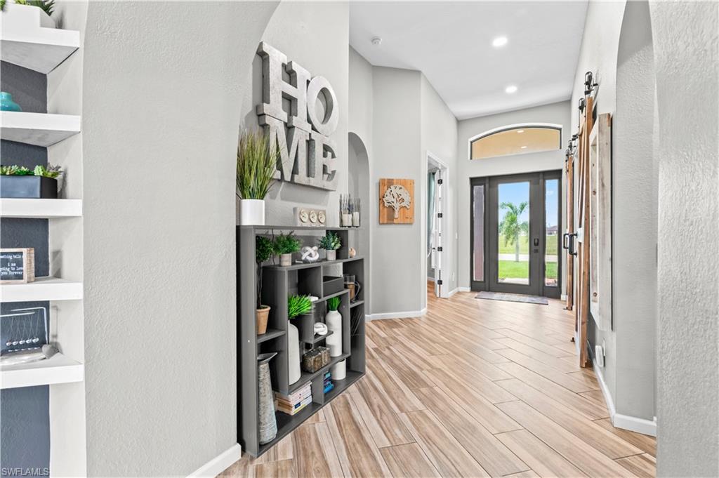2123 Old Burnt Store Road North Cape Coral, FL 33993 - Photo 4 of 40 a view of a hallway with wooden floor and entryway