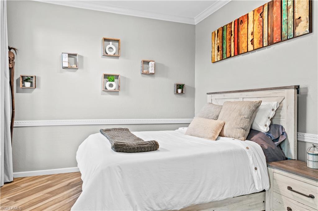 2123 Old Burnt Store Road North Cape Coral, FL 33993 - Photo 6 of 40 a bedroom with a bed and a painting on the wall