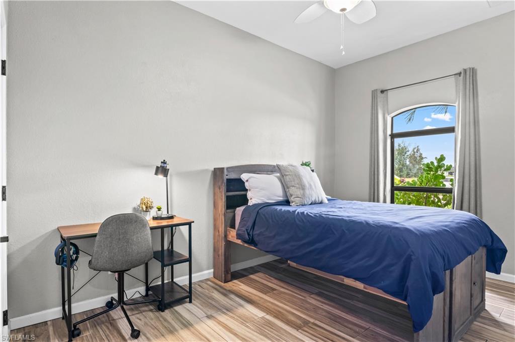 2123 Old Burnt Store Road North Cape Coral, FL 33993 - Photo 9 of 40 a bedroom with a bed and chair