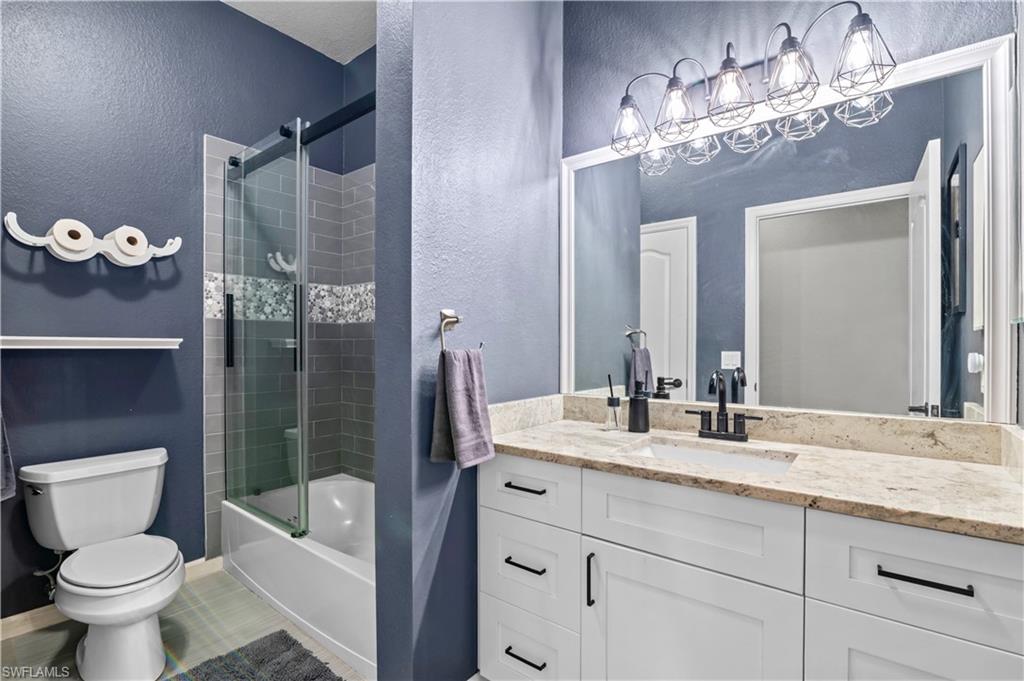 2123 Old Burnt Store Road North Cape Coral, FL 33993 - Photo 10 of 40 a bathroom with a granite countertop sink toilet and shower