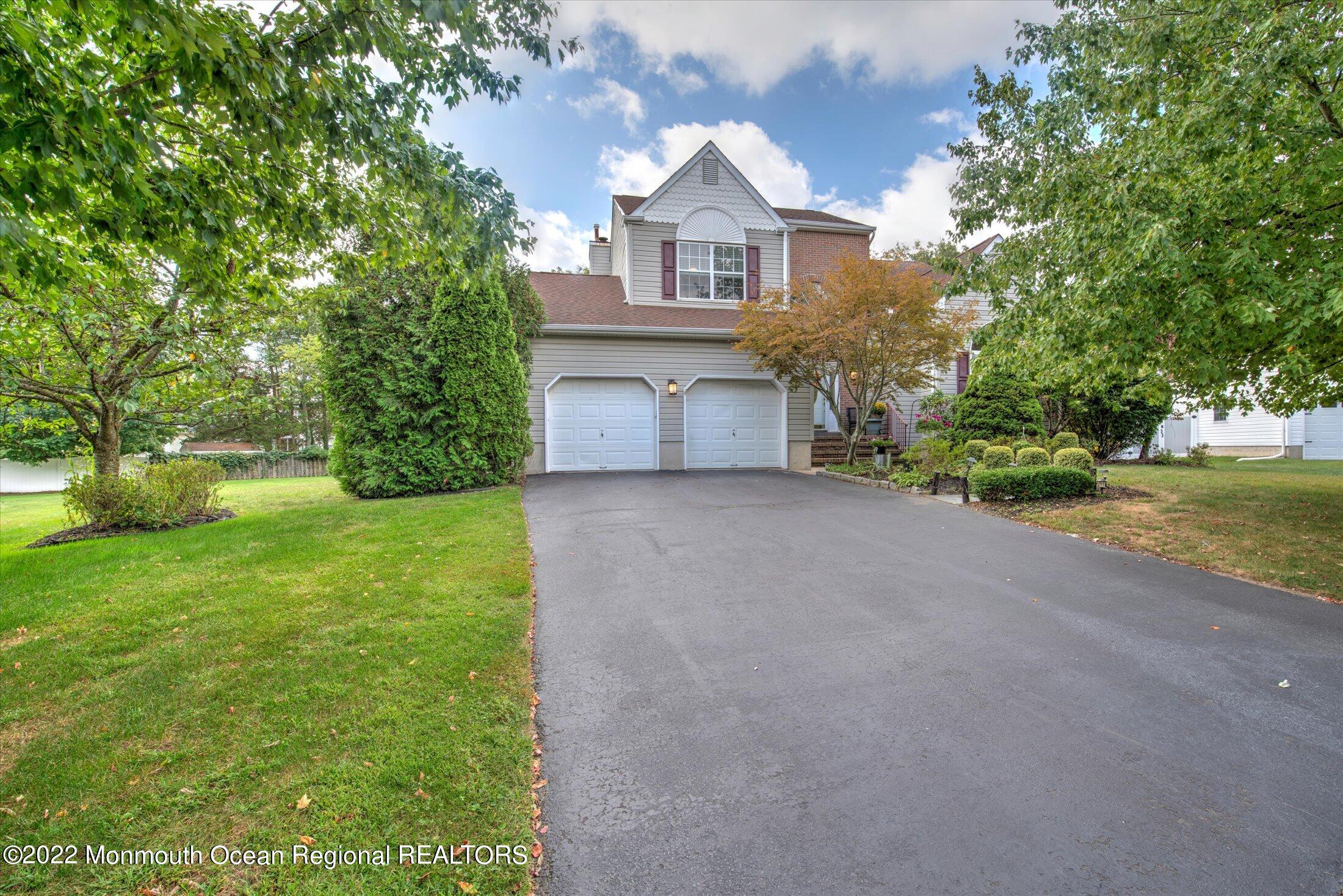 10 MacIntosh Court Jackson, NJ 08527 - Photo 1 of 49 a front view of a house with a yard and garage
