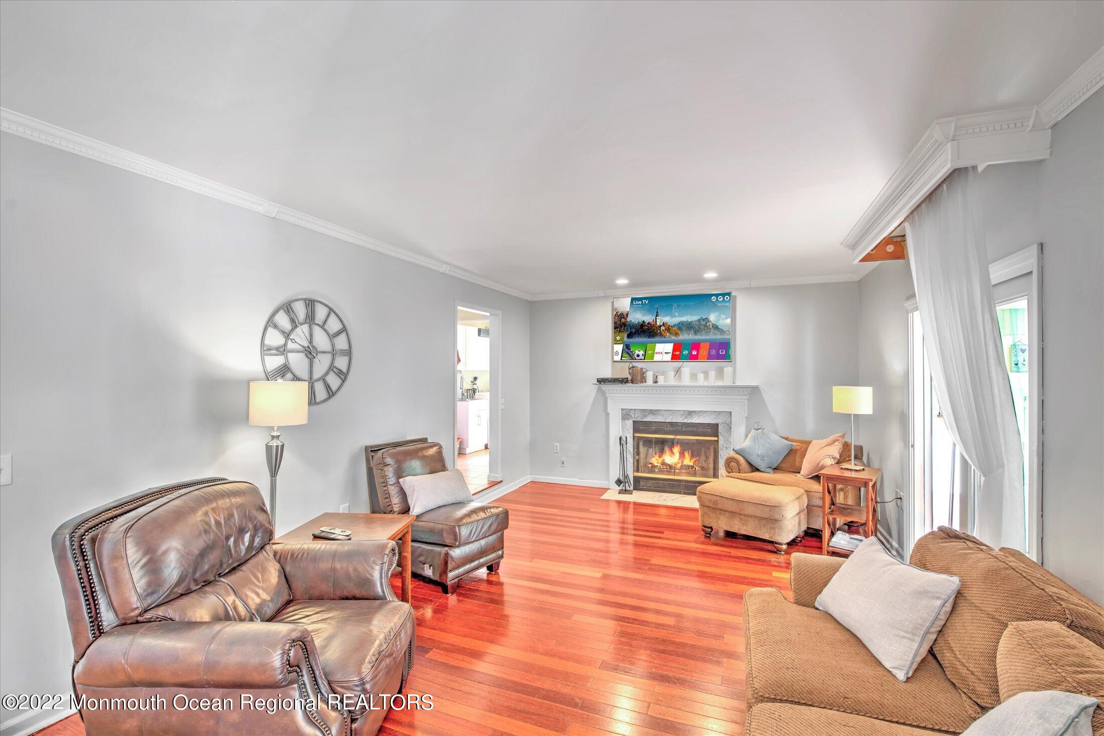 10 MacIntosh Court Jackson, NJ 08527 - Photo 13 of 49 a living room with fireplace furniture and a chandelier