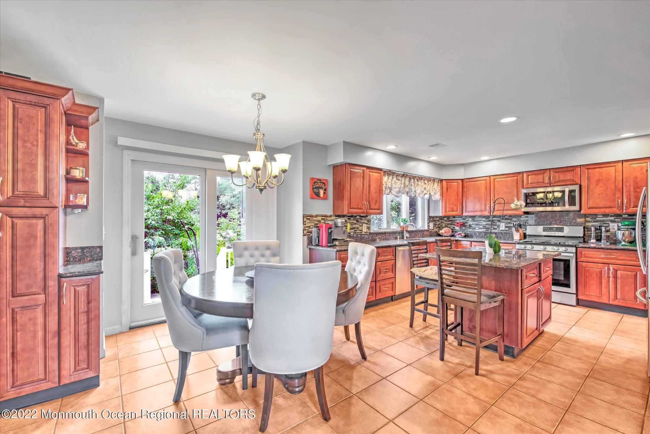 10 MacIntosh Court Jackson, NJ 08527 - Photo 20 of 49 a view of a dining room with furniture window and outside view
