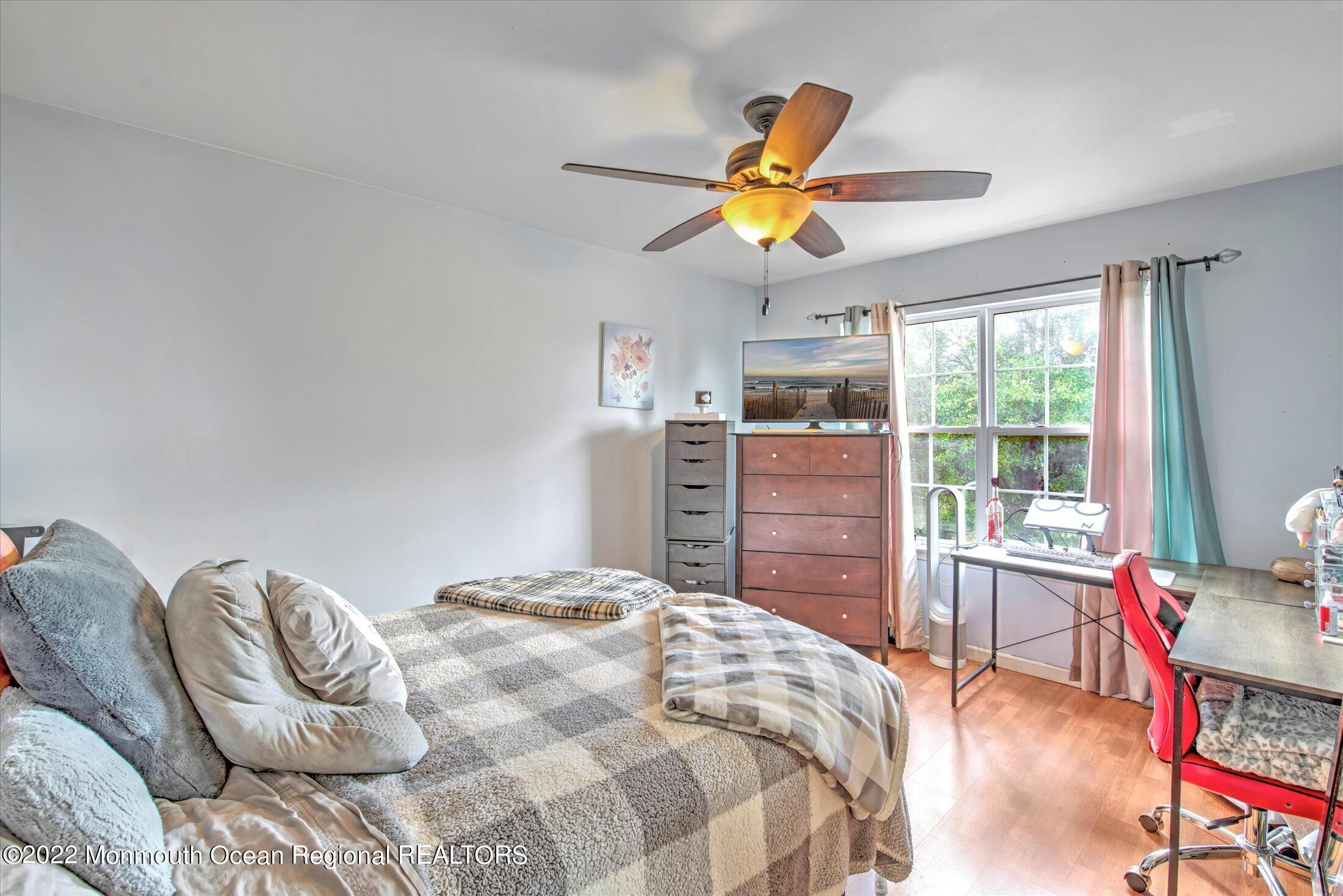 10 MacIntosh Court Jackson, NJ 08527 - Photo 38 of 49 a bedroom with a bed and wooden floor