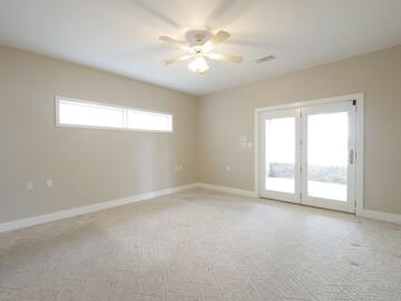 622 Nelson Point Road Niceville, FL 32578 - Photo 12 of 28 an empty room with windows and chandelier fan