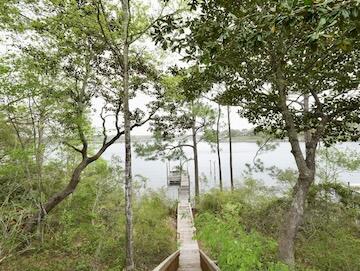 622 Nelson Point Road Niceville, FL 32578 - Photo 26 of 28 a backyard of a house with lots of green space