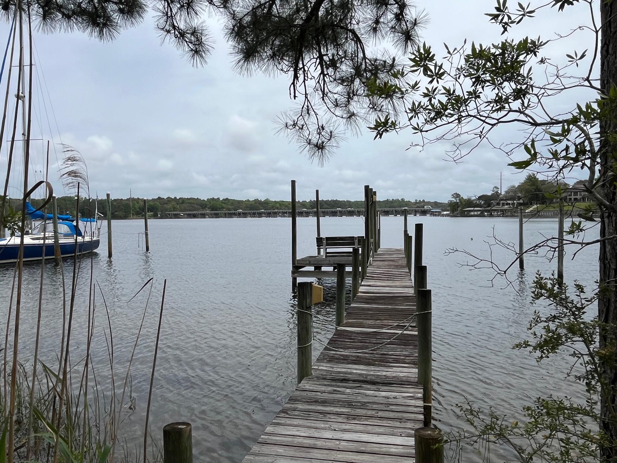 622 Nelson Point Road Niceville, FL 32578 - Photo 27 of 28 a view of a lake with boats and palm trees