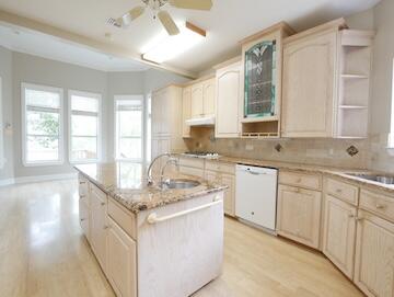 622 Nelson Point Road Niceville, FL 32578 - Photo 7 of 28 a kitchen with granite countertop a sink and white cabinets
