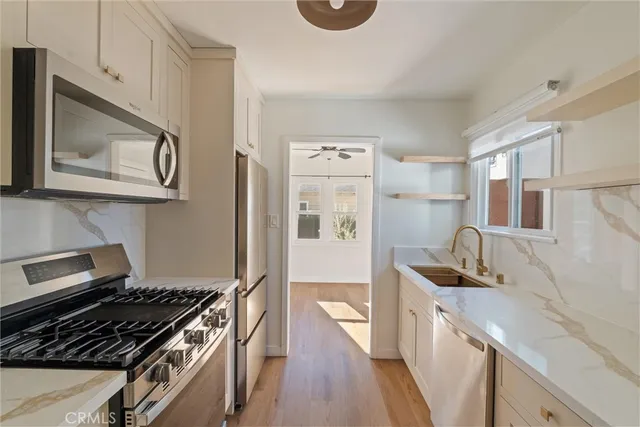 a kitchen with granite countertop a stove and a refrigerator
