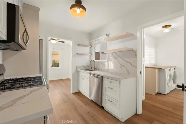 a kitchen with stainless steel appliances granite countertop a stove and a refrigerator