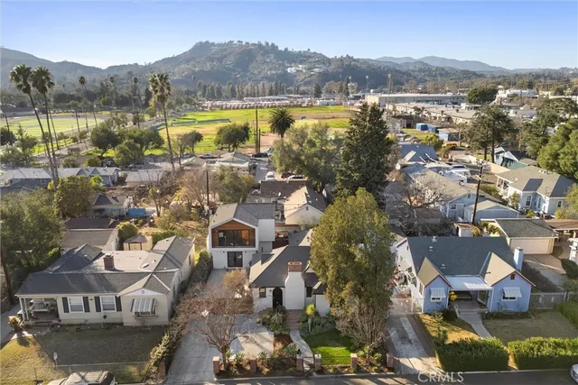 an aerial view of residential houses with outdoor space and river