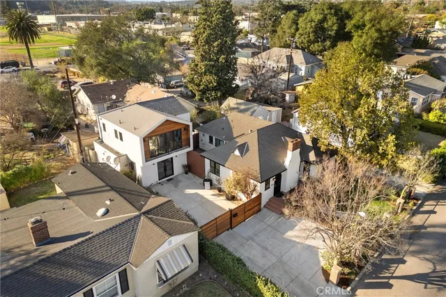 an aerial view of multiple houses with yard