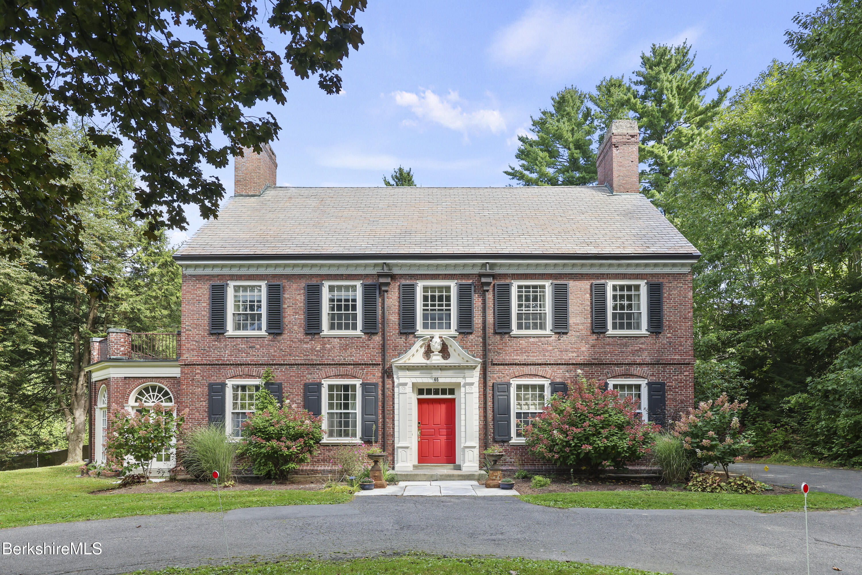 a front view of house with yard and green space