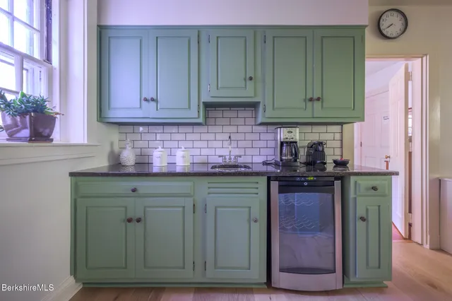 a living room with a bed furniture and a window