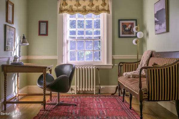 a bedroom with a bed and a view of living room