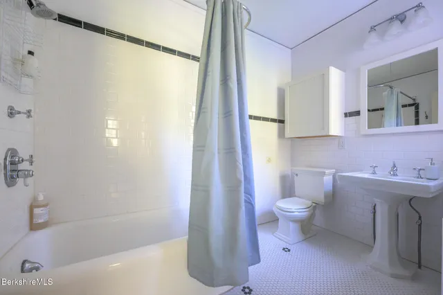 an aerial view of a house with swimming pool and garden