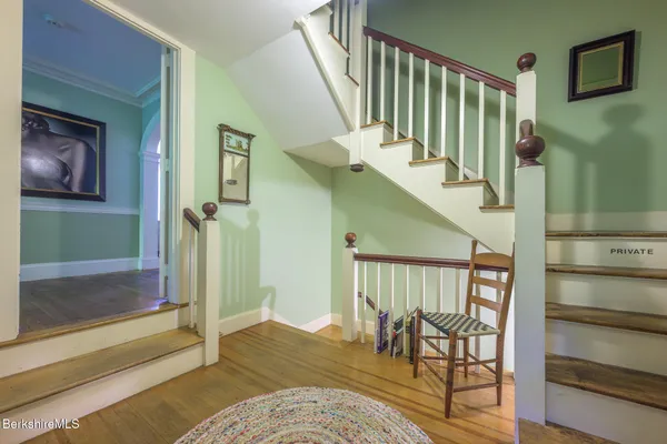 a view of a house with a yard and basketball court