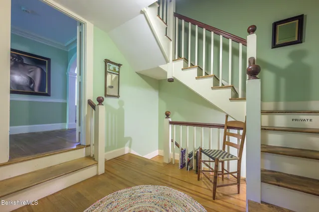 a view of a house with a yard and basketball court
