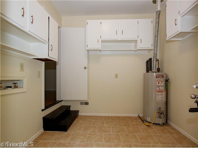 5110 Cheviot Road Greensboro, NC 27455 - Photo 12 of 16 Laundry Room. The oversized laundry room, utility/mud room, is a great space for storage and features new flooring, refinished cabinetry, fresh paint, new lighting!