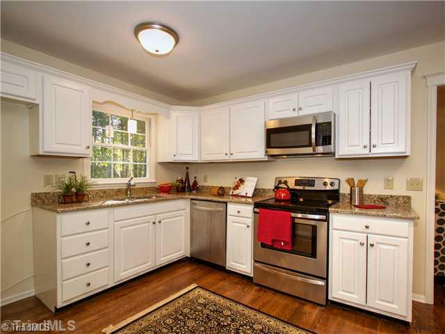 5110 Cheviot Road Greensboro, NC 27455 - Photo 4 of 16 Kitchen. A brand new kitchen awaits you: Brand new cabinet doors and hardware, granite countertops, brand new stainless appliances, sink and faucet. Brand new hardwood floors and updated lighting! A gorgeous space!
