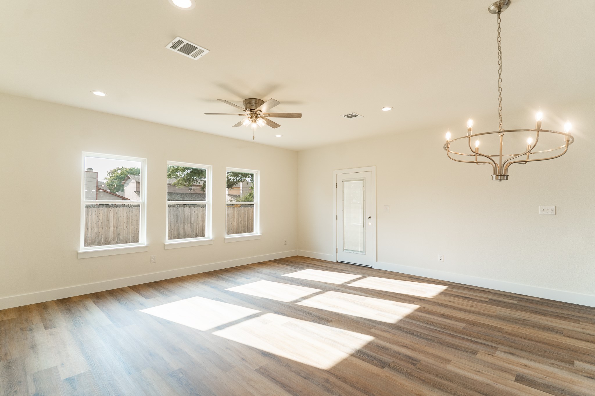 309 String Prairie Way Smithville, TX 78957 - Photo 9 of 30 a view of an empty room with wooden floor and a window