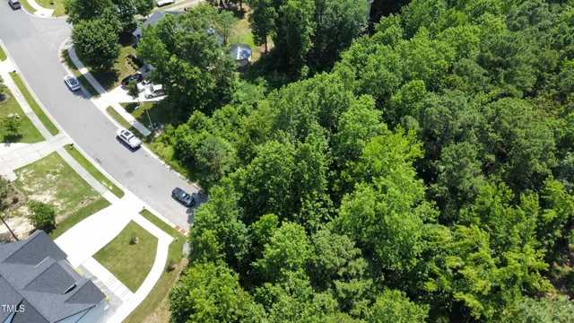 an aerial view of a house with a yard swimming pool and outdoor seating