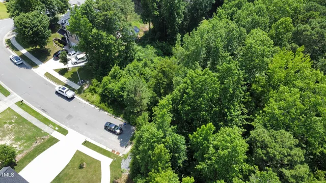 an aerial view of a residential houses with yard