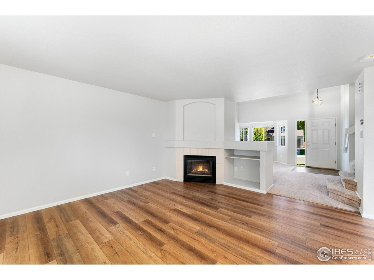 5415 Wolf Street Frederick, CO 80504 - Photo 11 of 29 a view of empty room with kitchen and fireplace