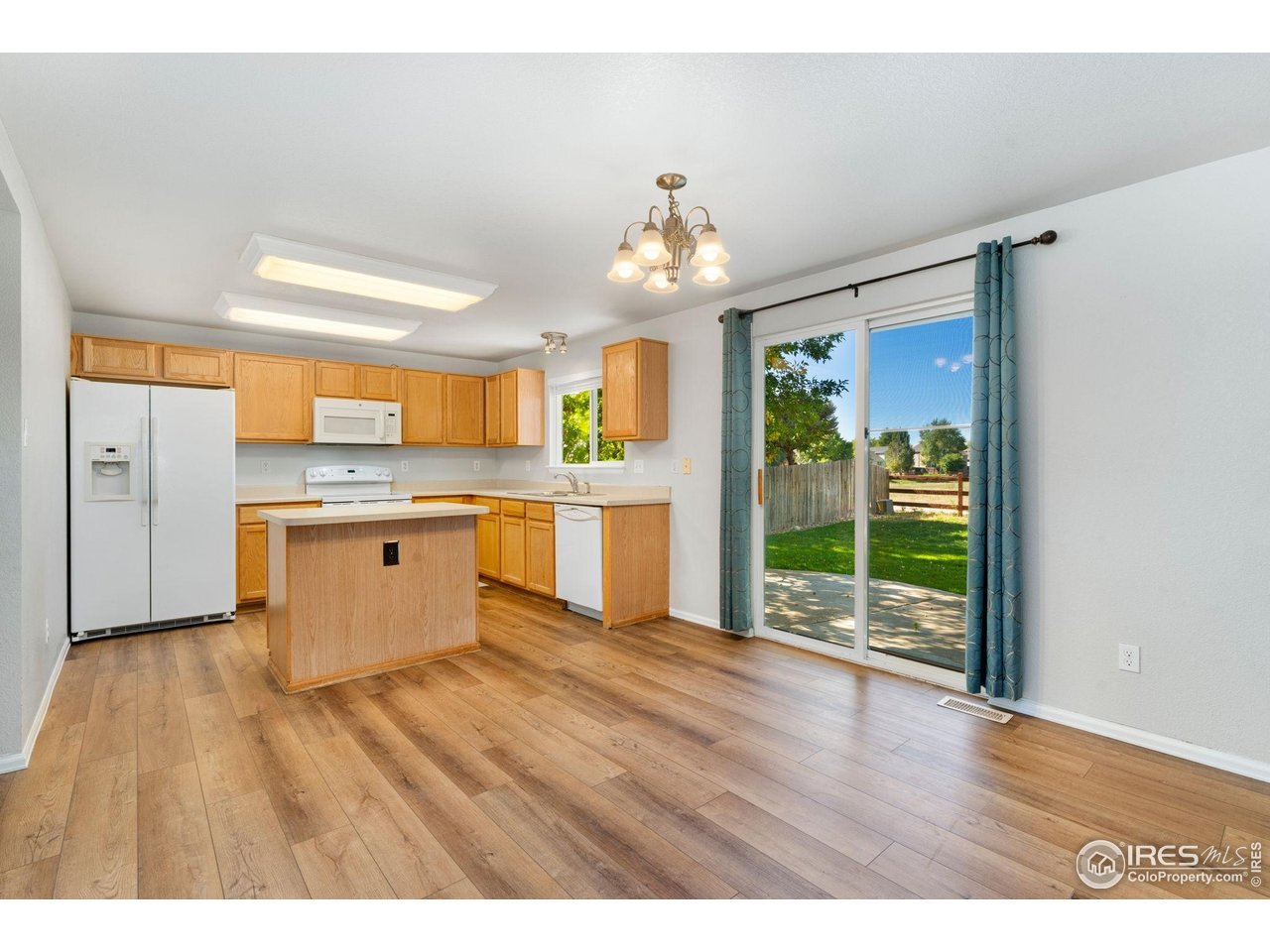 5415 Wolf Street Frederick, CO 80504 - Photo 13 of 29 a view of kitchen with granite countertop cabinets and wooden floor