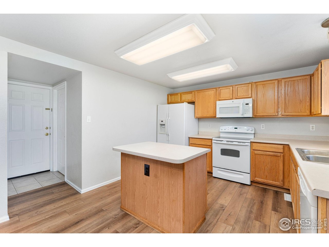 5415 Wolf Street Frederick, CO 80504 - Photo 14 of 29 a kitchen with granite countertop a sink cabinets stainless steel appliances and a window