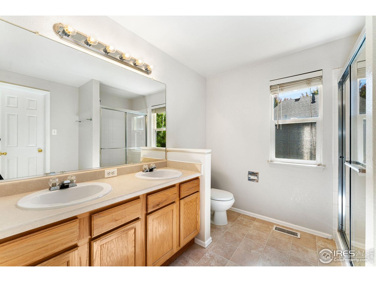 5415 Wolf Street Frederick, CO 80504 - Photo 24 of 29 a bathroom with a sink a toilet and mirror