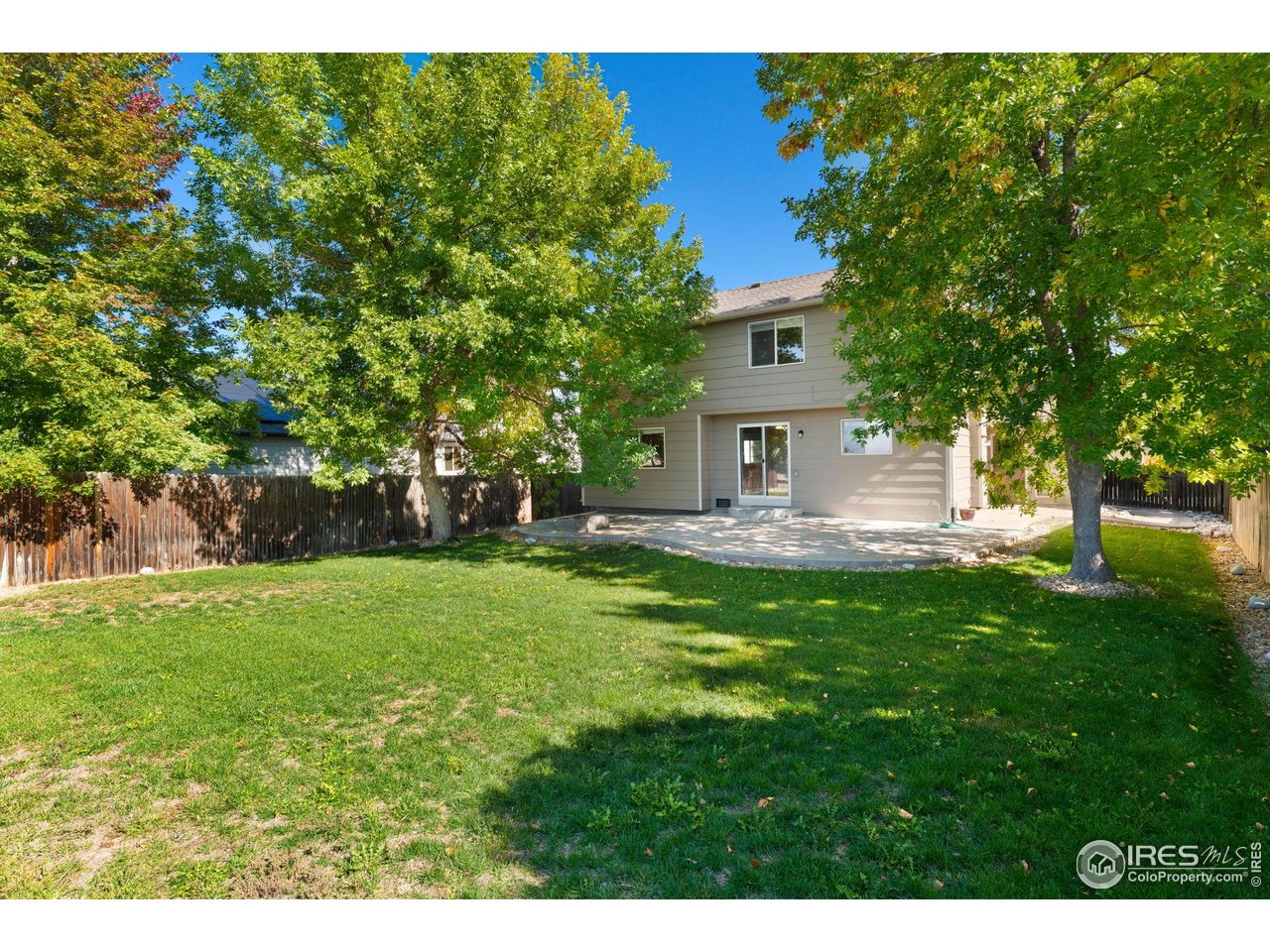 5415 Wolf Street Frederick, CO 80504 - Photo 28 of 29 a view of a house with backyard and a tree