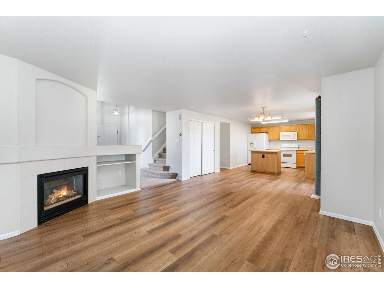 5415 Wolf Street Frederick, CO 80504 - Photo 8 of 29 a view of empty room with wooden floor and fireplace