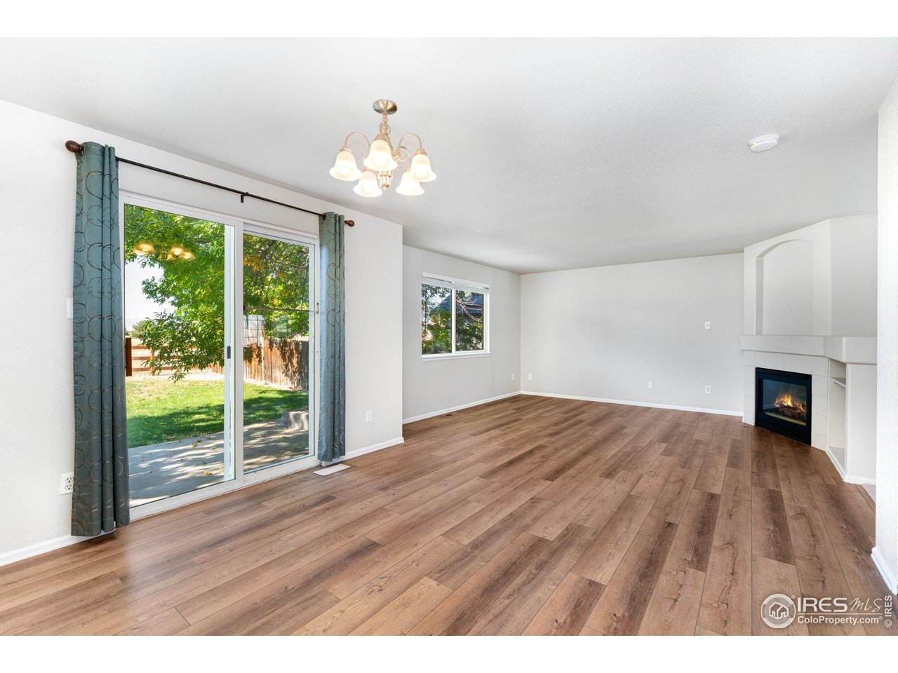 5415 Wolf Street Frederick, CO 80504 - Photo 10 of 29 a view of an empty room with wooden floor and a window