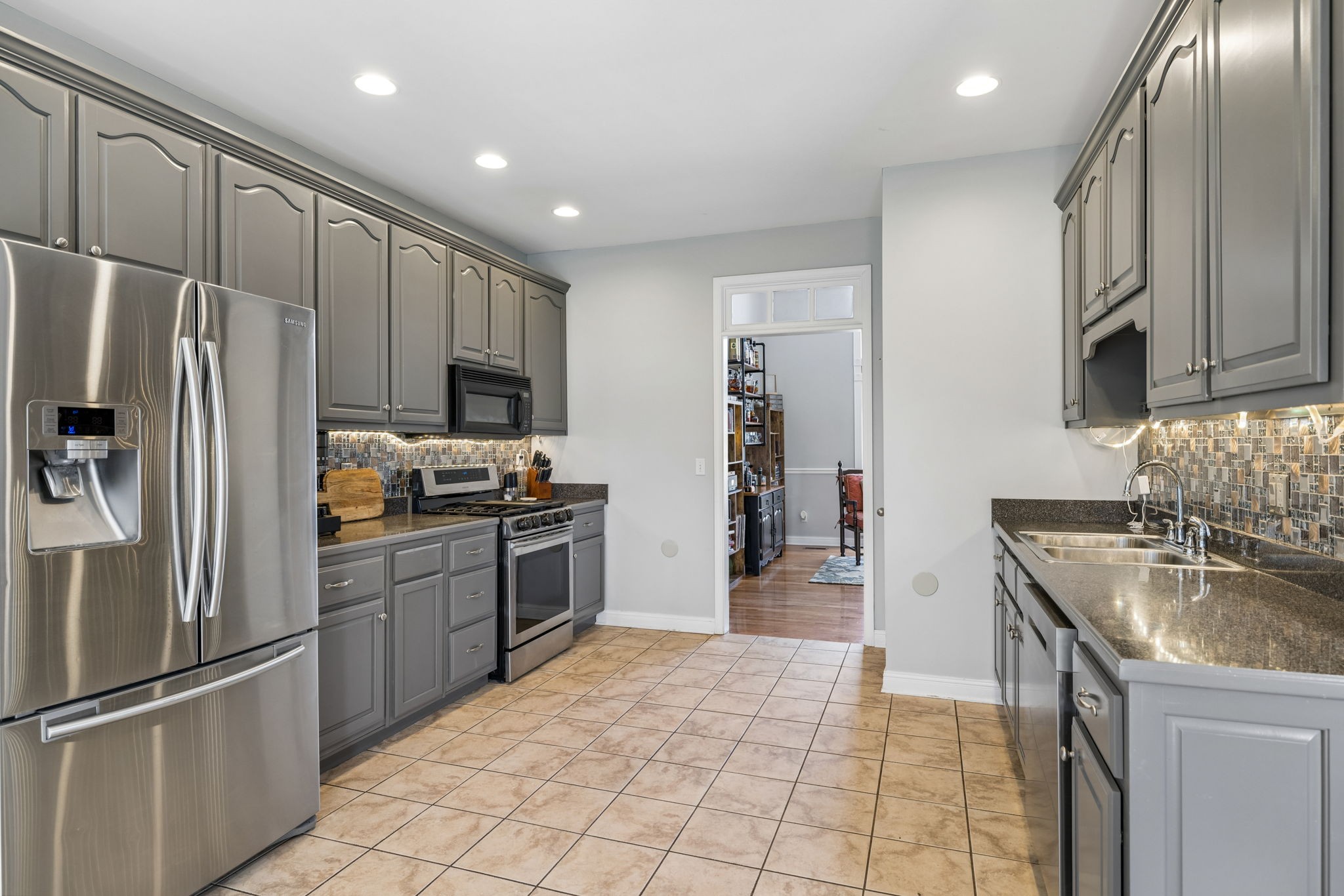 1062 Kacie Drive Pleasant View, TN 37146 - Photo 30 of 67 a kitchen with granite countertop a refrigerator stove top oven and sink