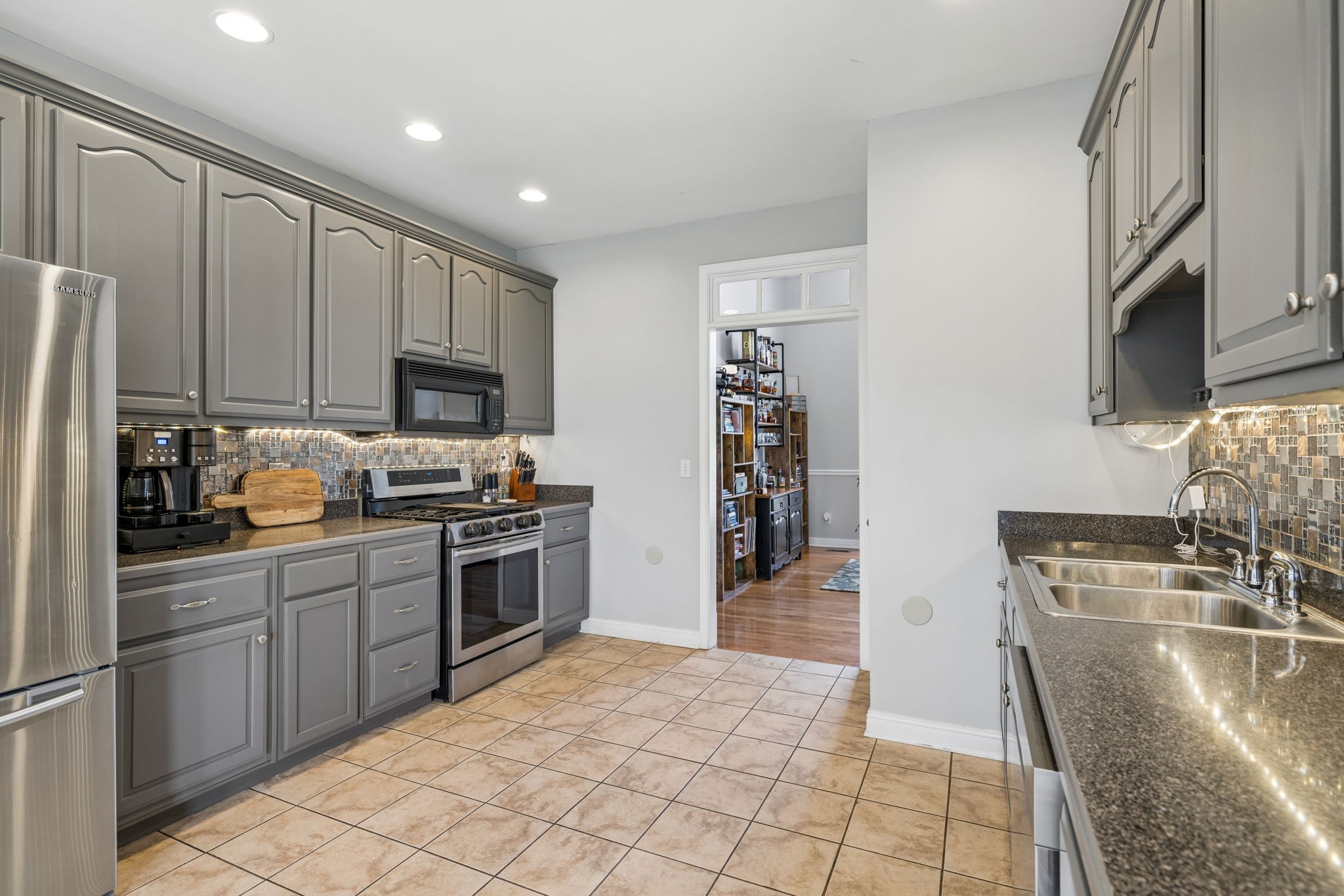 1062 Kacie Drive Pleasant View, TN 37146 - Photo 31 of 67 a kitchen with stainless steel appliances granite countertop a stove top oven a sink a refrigerator and white cabinets