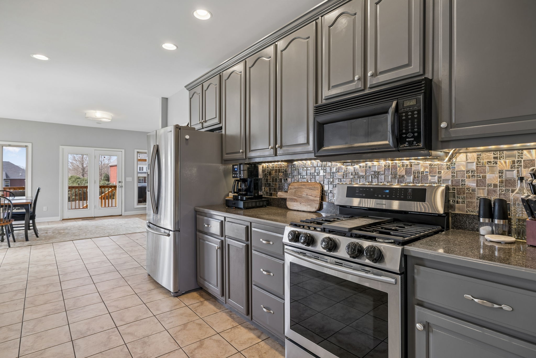 1062 Kacie Drive Pleasant View, TN 37146 - Photo 36 of 67 a kitchen with granite countertop a stove top oven microwave and cabinets