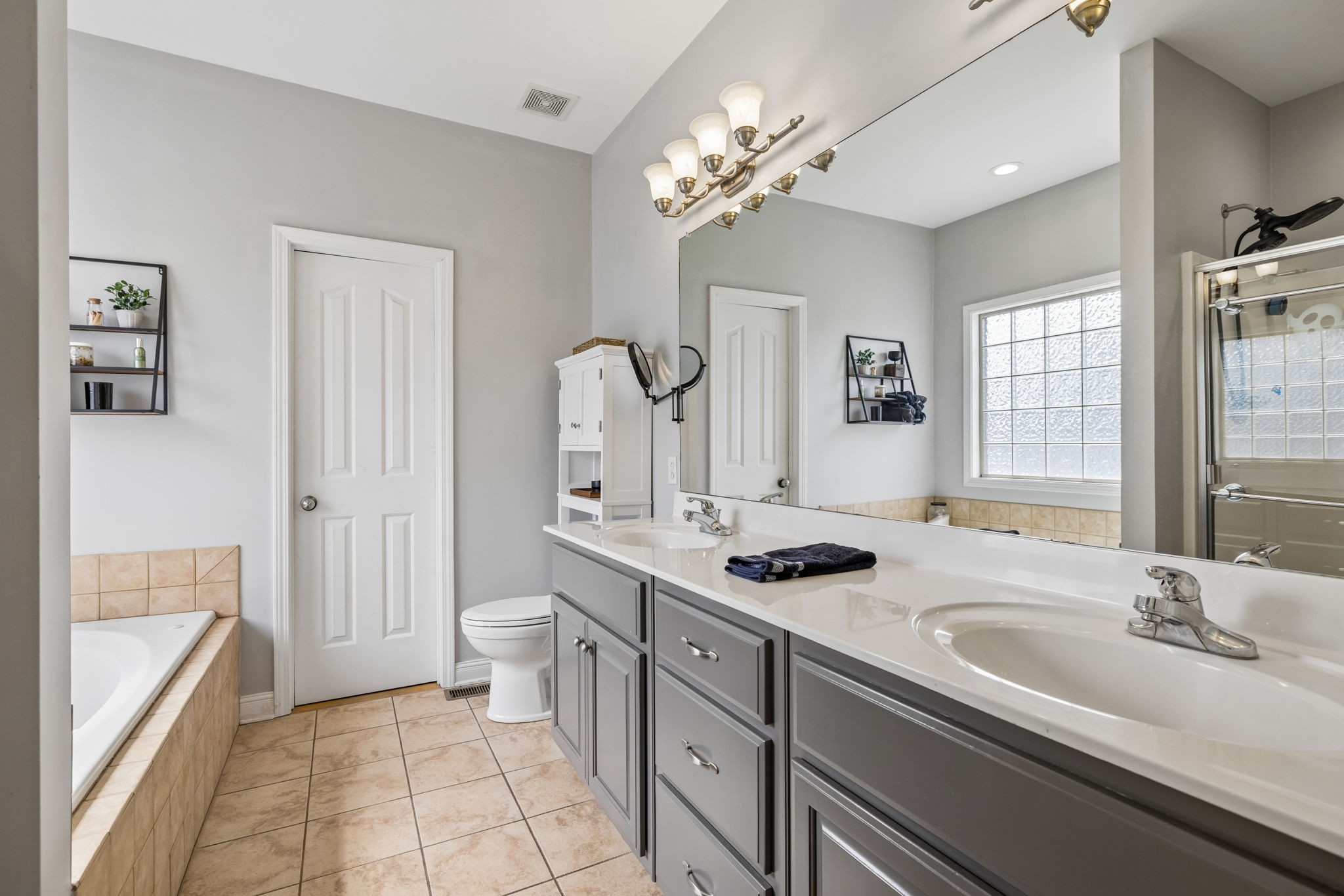 1062 Kacie Drive Pleasant View, TN 37146 - Photo 40 of 67 a bathroom with a sink a toilet a mirror and shower