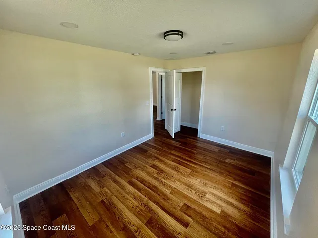 a view of a room with wooden floor and staircase