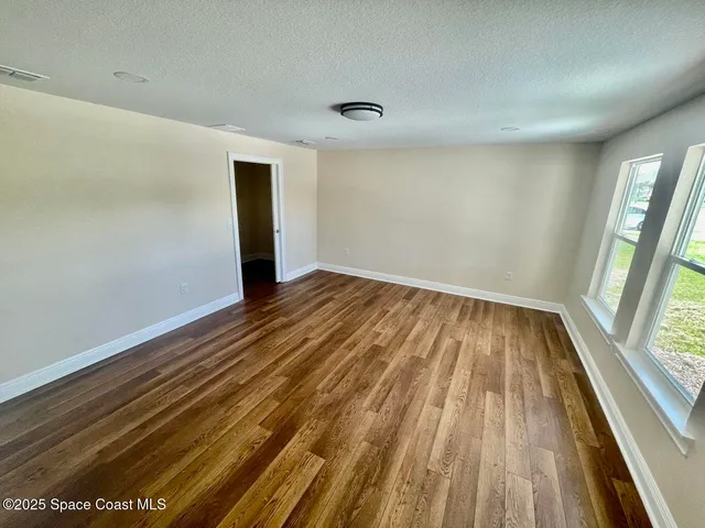 a view of wooden floor in an empty room