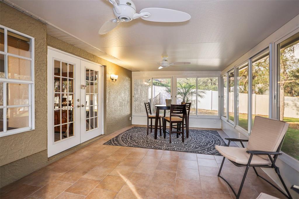 8412 Christopher Lane Weeki Wachee, FL 34613 - Photo 9 of 41 a dining room with furniture a chandelier and wooden floor