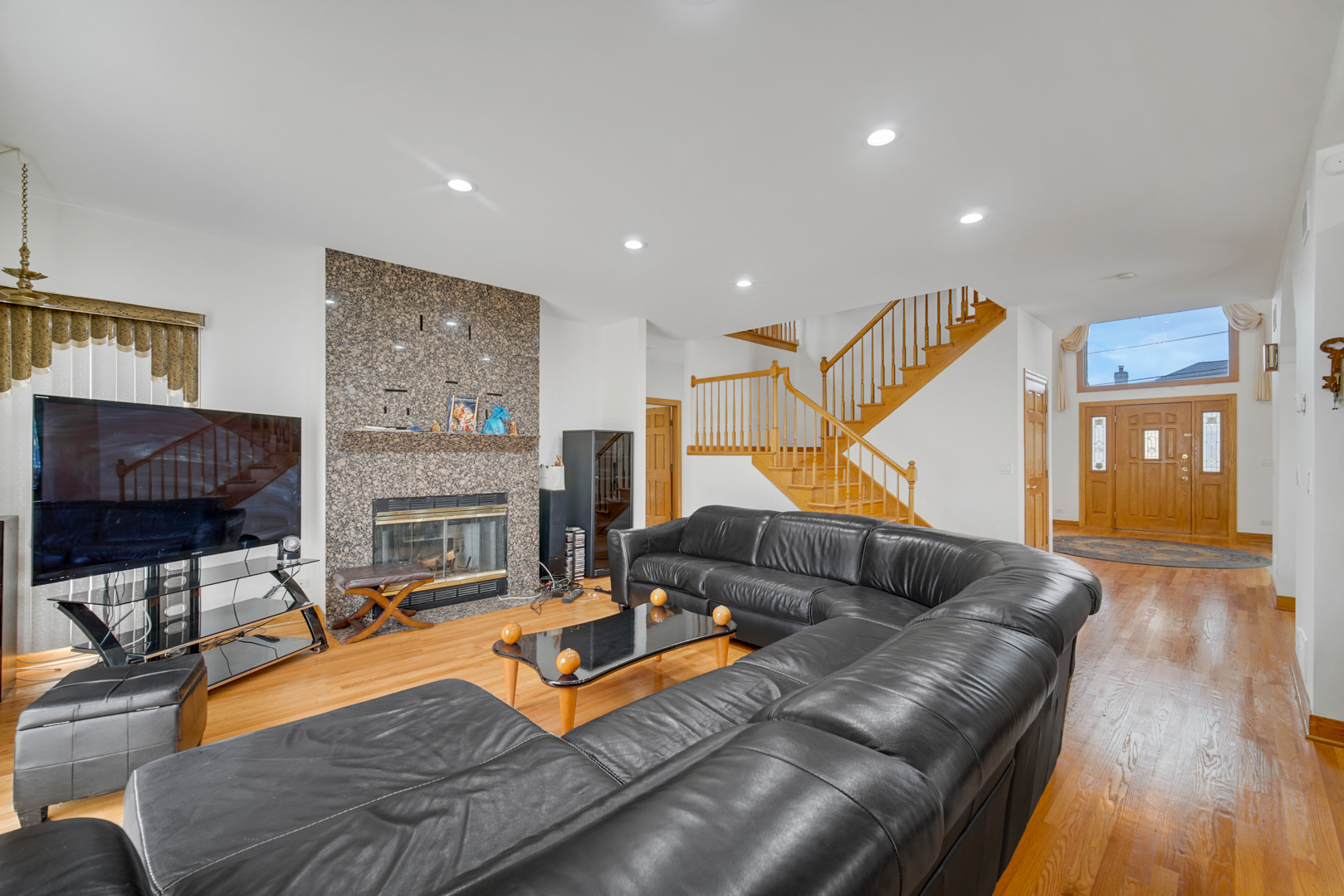 9131 Delphia Street Des Plaines, IL 60016 - Photo 4 of 14 a living room with furniture and a fireplace
