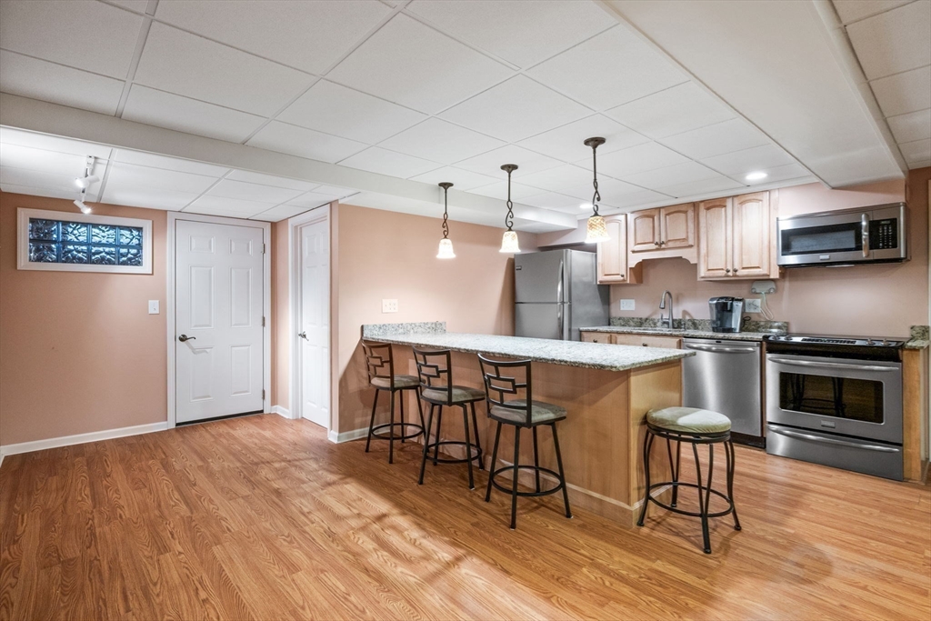 20 Stagecoach Road Topsfield, MA 01983 - Photo 33 of 42 a kitchen with granite countertop a stove a sink and a refrigerator