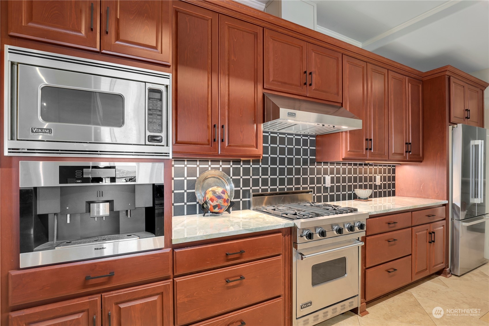 207 Broadway, Unit 500 Tacoma, WA 98402 - Photo 14 of 40 a kitchen with stainless steel appliances granite countertop a stove microwave and cabinets