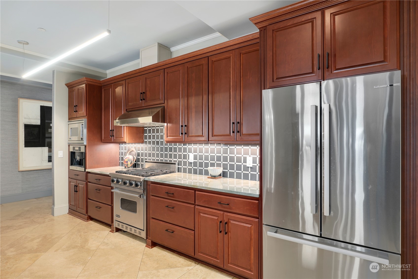 207 Broadway, Unit 500 Tacoma, WA 98402 - Photo 15 of 40 a kitchen with stainless steel appliances granite countertop a refrigerator and a stove top oven