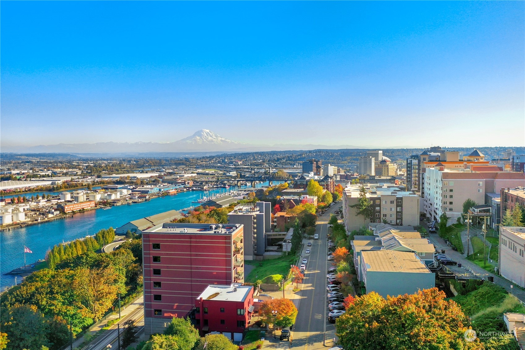 207 Broadway, Unit 500 Tacoma, WA 98402 - Photo 2 of 40 an aerial view of a city with lots of residential buildings ocean and mountain view in back