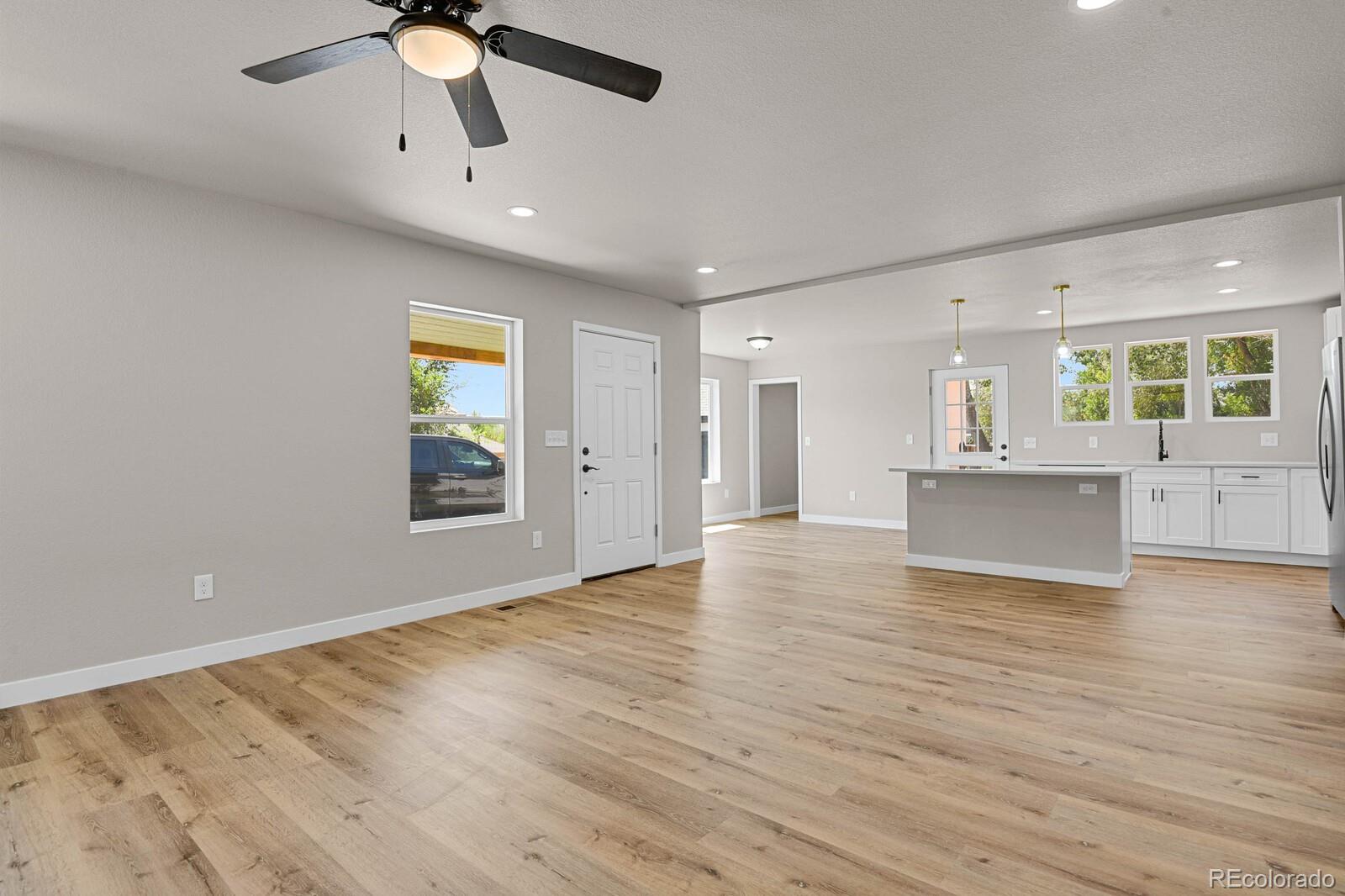 407 Hover Street Longmont, CO 80503 - Photo 7 of 39 wooden floor in an empty room with a window