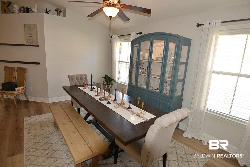 11201 Herschel Loop Daphne, AL 36526 - Photo 11 of 32 Dining area with vaulted ceiling, light wood-type flooring, a healthy amount of sunlight, and ceiling fan
